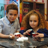 Two kids enjoying Cold Stone Ice Cream